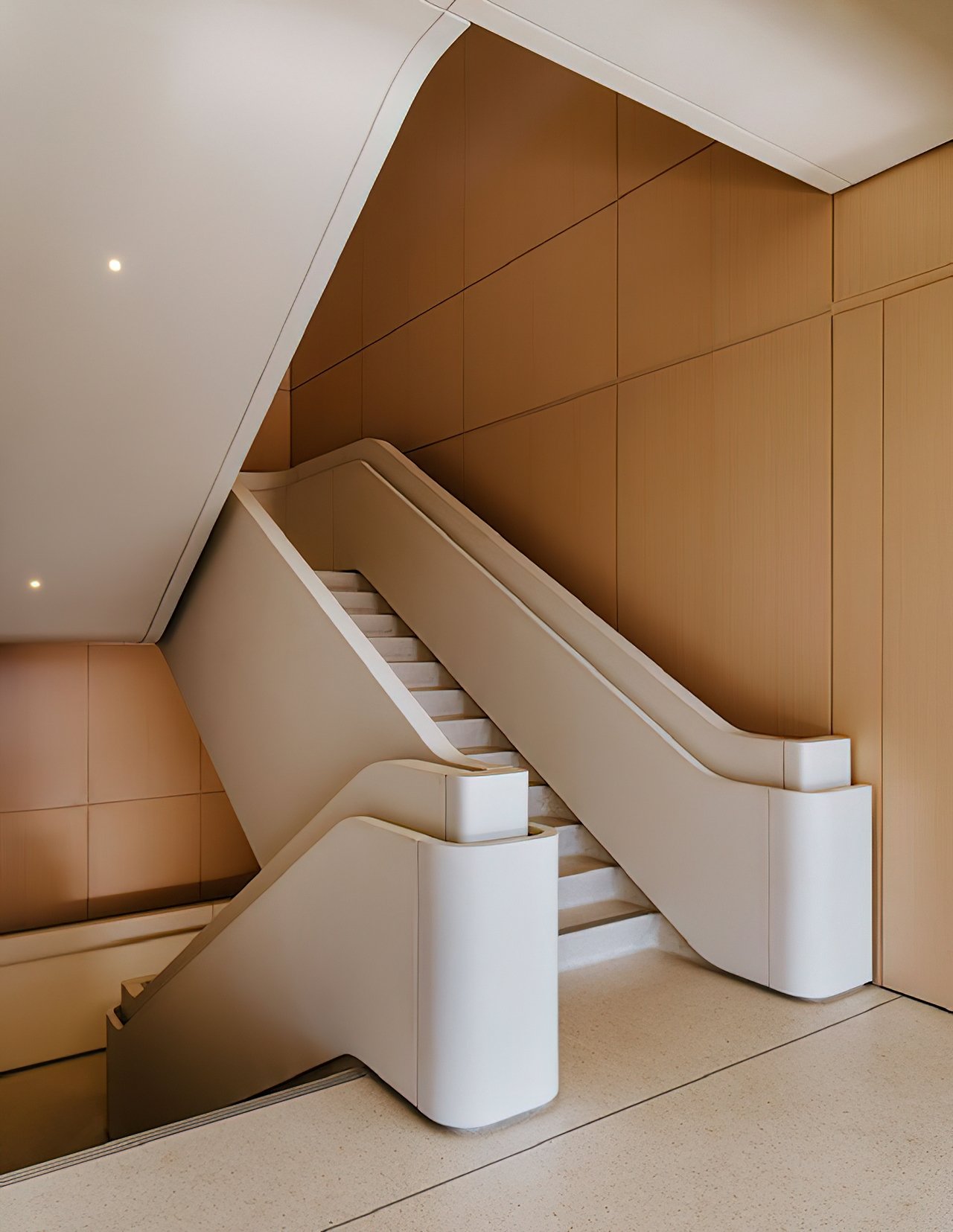 Interior path with planters, soft light, and long glass walls.